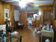 Living room showcasing hardwood floors and wood-paneled walls with an open view to the kitchen at 2795 Dodson Lee Dr, East Point, GA 30344