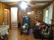 Cozy living room features wood paneling, hardwood floors, and a comfortable seating area at 2795 Dodson Lee Dr, East Point, GA 30344