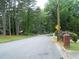 View of a quiet street lined with mature trees and well-kept lawns at 2795 Dodson Lee Dr, East Point, GA 30344