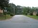A residential street view with mature trees and a street sign at 2795 Dodson Lee Dr, East Point, GA 30344