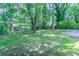 Large grassy backyard with scattered trees, partially fenced in, with a home in the background at 3938 Emerald Springs Ct, Decatur, GA 30035