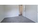 Empty bedroom with carpet flooring, neutral walls and trim, and one door at 3938 Emerald Springs Ct, Decatur, GA 30035