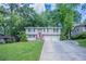 Split level home featuring a large front yard and attached two car garage at 3938 Emerald Springs Ct, Decatur, GA 30035