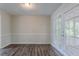 Bright living room with wood floors and a view of the outdoors through the white framed glass doors at 3938 Emerald Springs Ct, Decatur, GA 30035