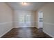 Bright dining room with wood floors and glass doors leading to the backyard, with an open doorway to a room at 3938 Emerald Springs Ct, Decatur, GA 30035