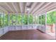 Sunroom featuring wood floors, white trim, screens, and multiple windows at 3938 Emerald Springs Ct, Decatur, GA 30035