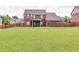 Large backyard featuring a lush lawn, a wood privacy fence, and the rear of the home at 609 Turnbill Dr, Mcdonough, GA 30252