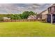 Spacious backyard with green grass, a wood fence, and views of surrounding houses at 609 Turnbill Dr, Mcdonough, GA 30252