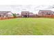 Expansive backyard with lush green grass, fenced perimeter, and view of the house at 609 Turnbill Dr, Mcdonough, GA 30252