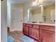 Inviting bathroom with a double vanity, large mirror, and walk-in shower at 609 Turnbill Dr, Mcdonough, GA 30252