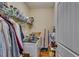 Functional laundry room with washer, dryer, storage shelves, and cleaning supplies at 609 Turnbill Dr, Mcdonough, GA 30252