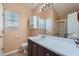 Bright bathroom with vanity, large mirror, and shower with glass door at 982 Hunt Rd, Jonesboro, GA 30236
