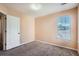 Bedroom with neutral walls and carpet flooring, naturally illuminated by a single window at 982 Hunt Rd, Jonesboro, GA 30236