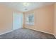 Bedroom with neutral walls and carpet flooring is naturally illuminated by a single window at 982 Hunt Rd, Jonesboro, GA 30236
