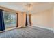 Carpeted bedroom with two windows, neutral walls, and ceiling fan at 982 Hunt Rd, Jonesboro, GA 30236