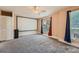 Spacious bedroom with ceiling fan, carpeted floors, and large windows with curtains at 982 Hunt Rd, Jonesboro, GA 30236