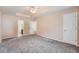 Spacious bedroom with soft carpet, ceiling fan, and adjacent bathroom at 982 Hunt Rd, Jonesboro, GA 30236