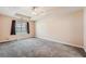 Large bedroom with carpet floors, tray ceiling, and a ceiling fan at 982 Hunt Rd, Jonesboro, GA 30236