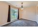 Cozy dining room with large window, decorative lighting, and neutral paint at 982 Hunt Rd, Jonesboro, GA 30236