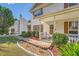 Close-up of home showcasing the landscaped front yard, walkway, and covered porch at 982 Hunt Rd, Jonesboro, GA 30236