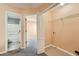 Hallway with tile laundry area leading into a bedroom and bathroom at 982 Hunt Rd, Jonesboro, GA 30236