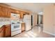 Updated kitchen with white appliances, wood cabinets, and a cozy breakfast area at 982 Hunt Rd, Jonesboro, GA 30236