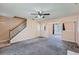Spacious living room featuring neutral walls, plush carpet, stairs, and large window at 982 Hunt Rd, Jonesboro, GA 30236