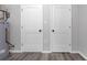 Basement storage featuring gray walls, modern flooring, and two storage doors at 1055 Mayson Turner Nw Rd, Atlanta, GA 30314