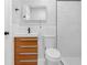 A bright bathroom with stylish wood vanity, white tile, and a glass enclosed shower at 1055 Mayson Turner Nw Rd, Atlanta, GA 30314