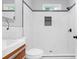A modern bathroom with stylish wood vanity, white tile, and a glass enclosed shower at 1055 Mayson Turner Nw Rd, Atlanta, GA 30314