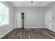 A bedroom with gray walls, wood flooring, window with blinds, and a closet at 1055 Mayson Turner Nw Rd, Atlanta, GA 30314
