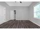 Bright bedroom with gray walls, modern wood flooring, window with blinds and closet at 1055 Mayson Turner Nw Rd, Atlanta, GA 30314