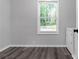 Bedroom featuring gray walls, modern wood flooring, and a window providing natural light at 1055 Mayson Turner Nw Rd, Atlanta, GA 30314