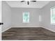 Bright bedroom featuring new dark wood-look floors and a ceiling fan at 1055 Mayson Turner Nw Rd, Atlanta, GA 30314