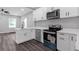 Bright kitchen with new stainless appliances, quartz counters, and dark floors at 1055 Mayson Turner Nw Rd, Atlanta, GA 30314