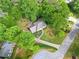 Stunning aerial view of lush landscaped property with mature trees and circular driveway at 1864 Gloucester Ct, Snellville, GA 30078