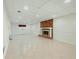 Finished basement with neutral tile flooring, fireplace, and a separate entrance to the exterior of the home at 1864 Gloucester Ct, Snellville, GA 30078