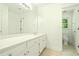 Bathroom with long vanity mirror and sink, and a secondary bathroom through an open door at 1864 Gloucester Ct, Snellville, GA 30078