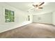 Spacious bedroom featuring neutral carpet and several windows for ample natural light at 1864 Gloucester Ct, Snellville, GA 30078