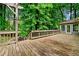 Wooden deck with stairs features direct access from the house and overlooks the beautiful, lush backyard at 1864 Gloucester Ct, Snellville, GA 30078