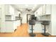 Bright eat-in kitchen with stainless appliances, bar seating and hardwood floors at 1864 Gloucester Ct, Snellville, GA 30078