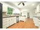 Spacious kitchen with white cabinets, black countertops, stainless steel appliances, and wood flooring at 1864 Gloucester Ct, Snellville, GA 30078