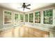 Bright sunroom with hardwood floors and multiple windows offering verdant views at 1864 Gloucester Ct, Snellville, GA 30078