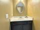 Bathroom with dark vanity, drawers and oval mirror at 2080 Village Station Xing, Smyrna, GA 30080