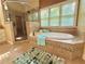 Modern bathroom with a soaking tub, glass shower, and bright natural light at 2080 Village Station Xing, Smyrna, GA 30080