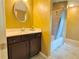 This bathroom has a brown vanity, round mirror and shower and tub combo at 2080 Village Station Xing, Smyrna, GA 30080