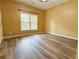 Well-lit bedroom with hardwood flooring, large window, and a neutral color scheme at 2080 Village Station Xing, Smyrna, GA 30080