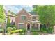 Charming two-story brick home with well-manicured landscaping and inviting entrance, nestled among mature trees at 2080 Village Station Xing, Smyrna, GA 30080