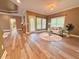 Open concept living room boasts lots of natural light, wood floors, and access to outdoor area at 2080 Village Station Xing, Smyrna, GA 30080