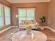 Inviting living room with large windows, wood floors, neutral tones, and a comfortable seating area at 2080 Village Station Xing, Smyrna, GA 30080